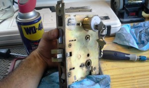 Eagle's locksmith is testing the new lock with the mechanism before installation.