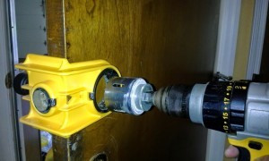 Lock Installation Services in Cincinnati, OH Metro Area Drilling a pip hole for a new lock installation by Eagle's Locksmith Cincinnati